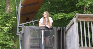 Girl on tram with paddle board